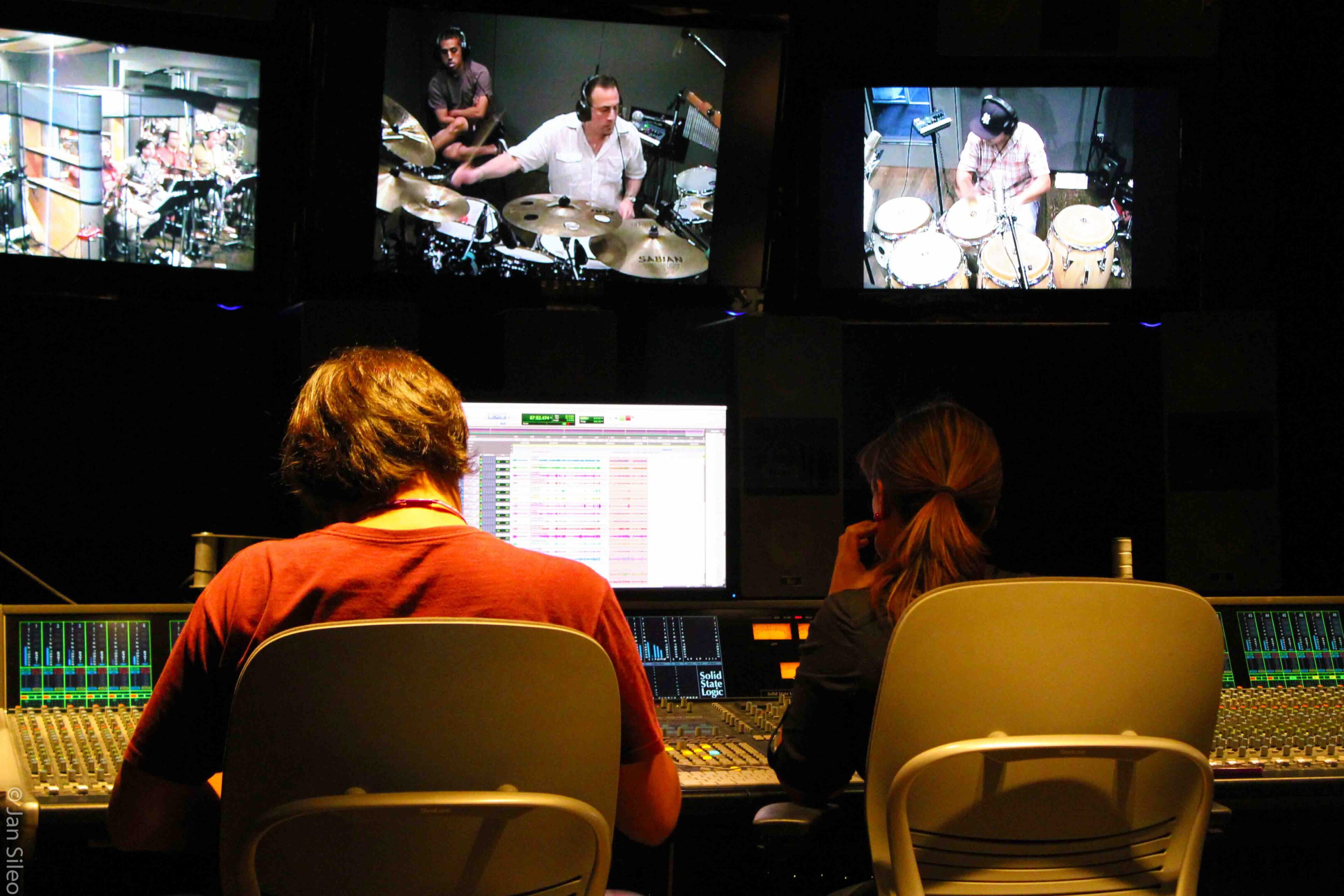 Producer_Engineers_IMG_2257_2011_cr Two people sitting at a table with computers and monitors.